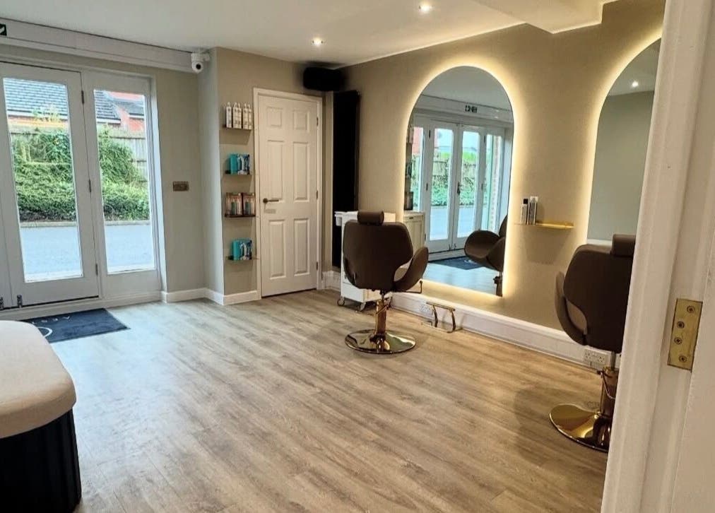 Modern salon interior at Blushed Bykyra, Upton, England, GB with stylish chairs and mirrored wall.