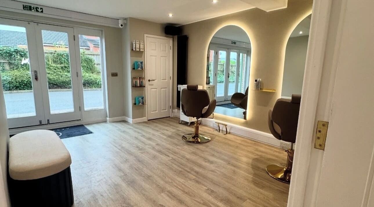 Modern salon interior at Blushed Bykyra, Upton, England, GB with stylish chairs and mirrored wall.