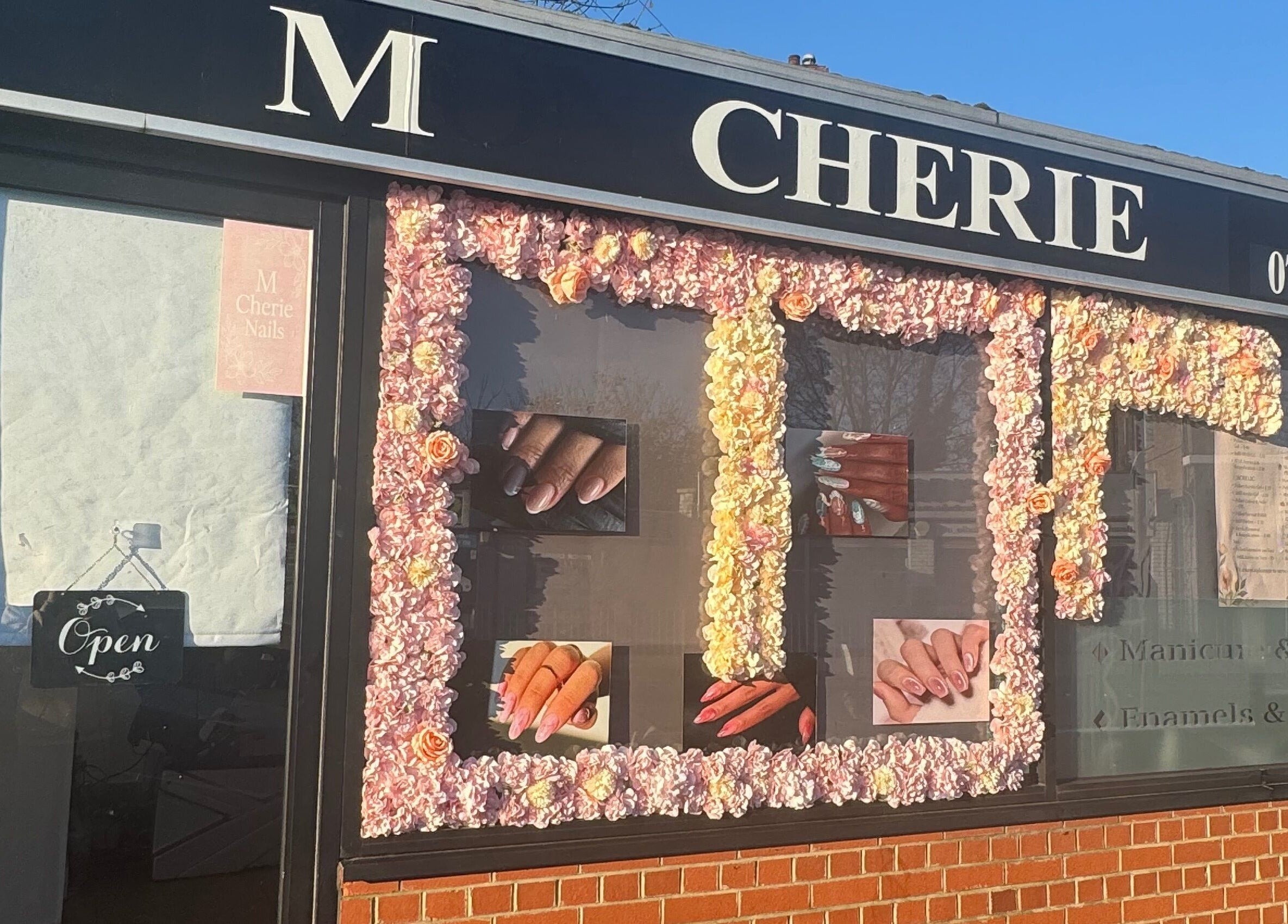 M Cherie Nails trên đường Hornchurch, Anh. Bảng hiệu với nét trang trí hoa ấn tượng.