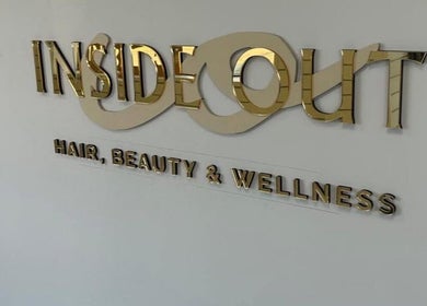 Gold signage of Inside Out Hair Beauty Wellness in Seaham, England, GB, showcasing its elegant branding.