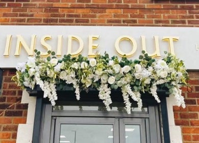 Shopfront of Inside Out Hair Beauty Wellness, Seaham, England, GB with floral decorations.