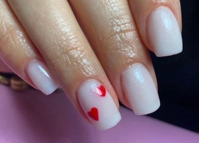 Stylish white nails with red hearts at Dream Nails by Anna, Barking, England, GB.
