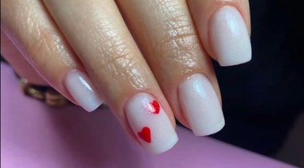 Stylish white nails with red hearts at Dream Nails by Anna, Barking, England, GB.