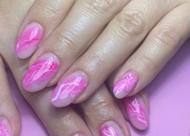 Bright pink swirl nail art at Dream Nails by Anna, Barking, England, GB. Perfectly manicured hands displayed.