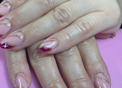 Red and gold nail art at Dream Nails by Anna in Barking, England, GB, showcasing creativity and elegance.