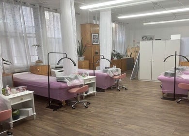Elegant treatment room at Lash Paradise, New York, New York, US, featuring plush pink beds and chic decor.