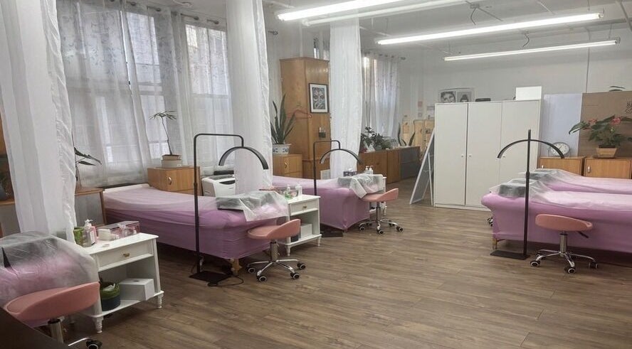 Tranquil treatment area at Lash Paradise, New York, New York, US with pink spa beds and soft lighting.