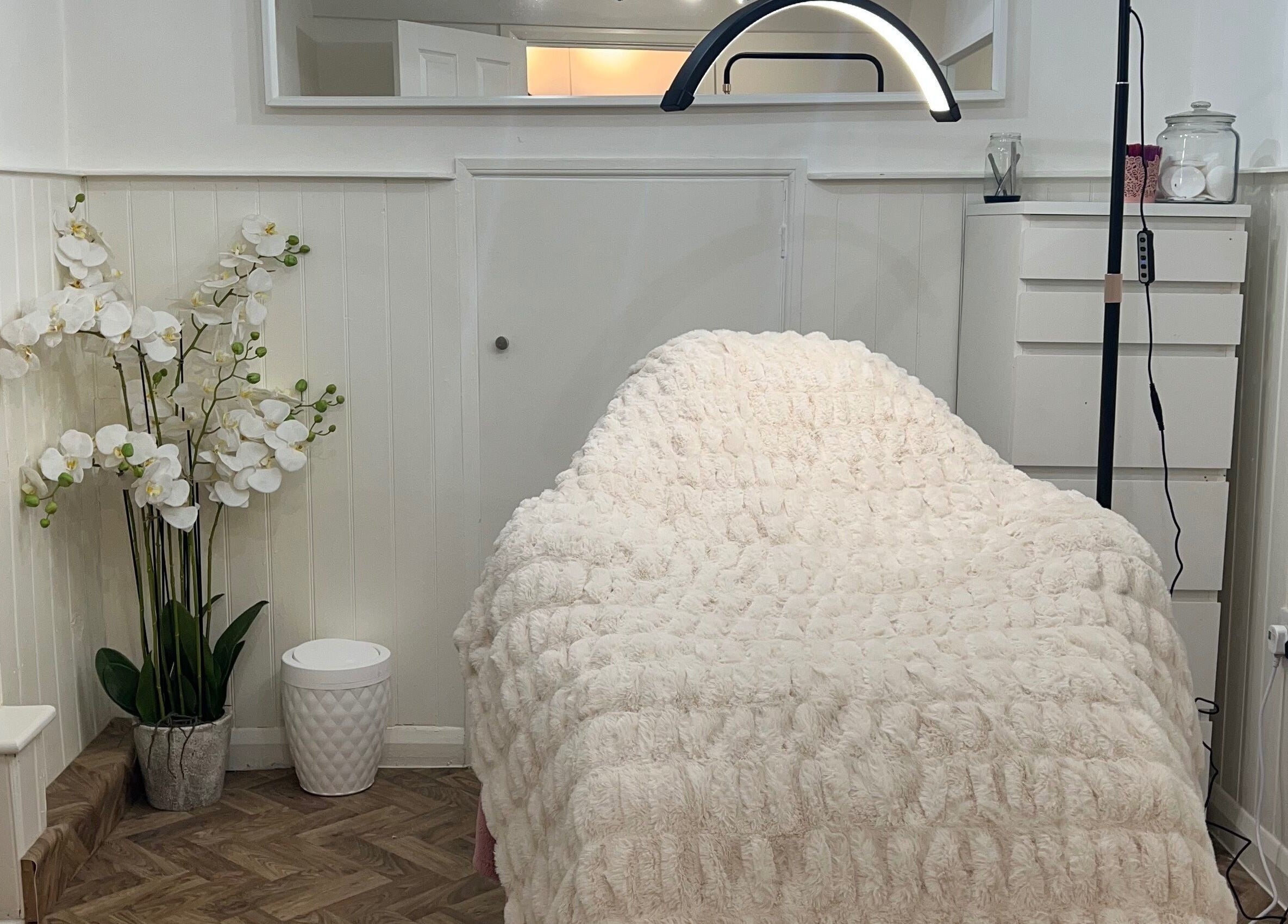 Luxurious treatment room at Lashes by Em, Harrogate, England, GB with a plush cover and elegant decor.