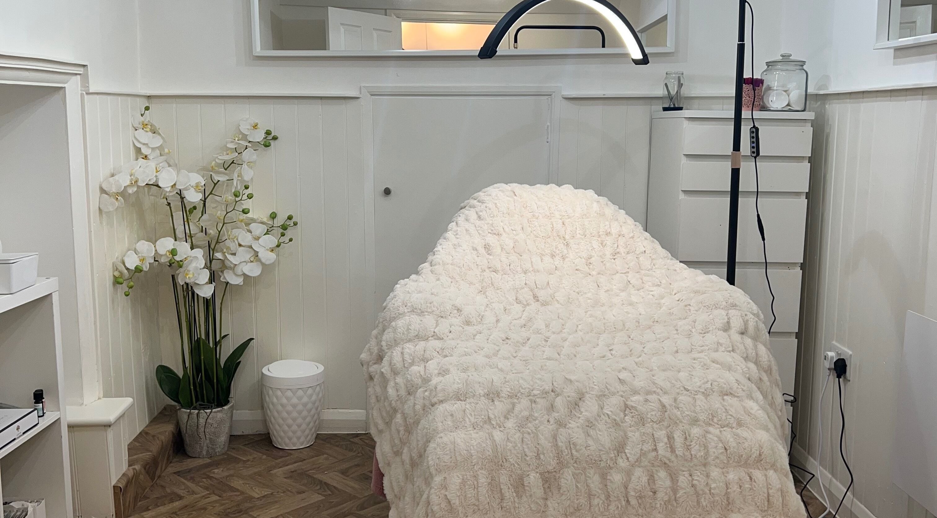 Luxurious treatment room at Lashes by Em, Harrogate, England, GB with a plush cover and elegant decor.