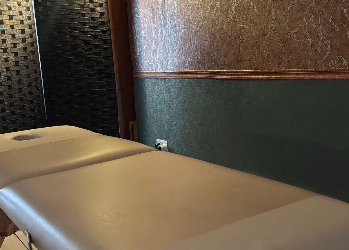 Luxurious massage table at Feniks, Valletta, MT with elegant wall accents for ultimate relaxation.