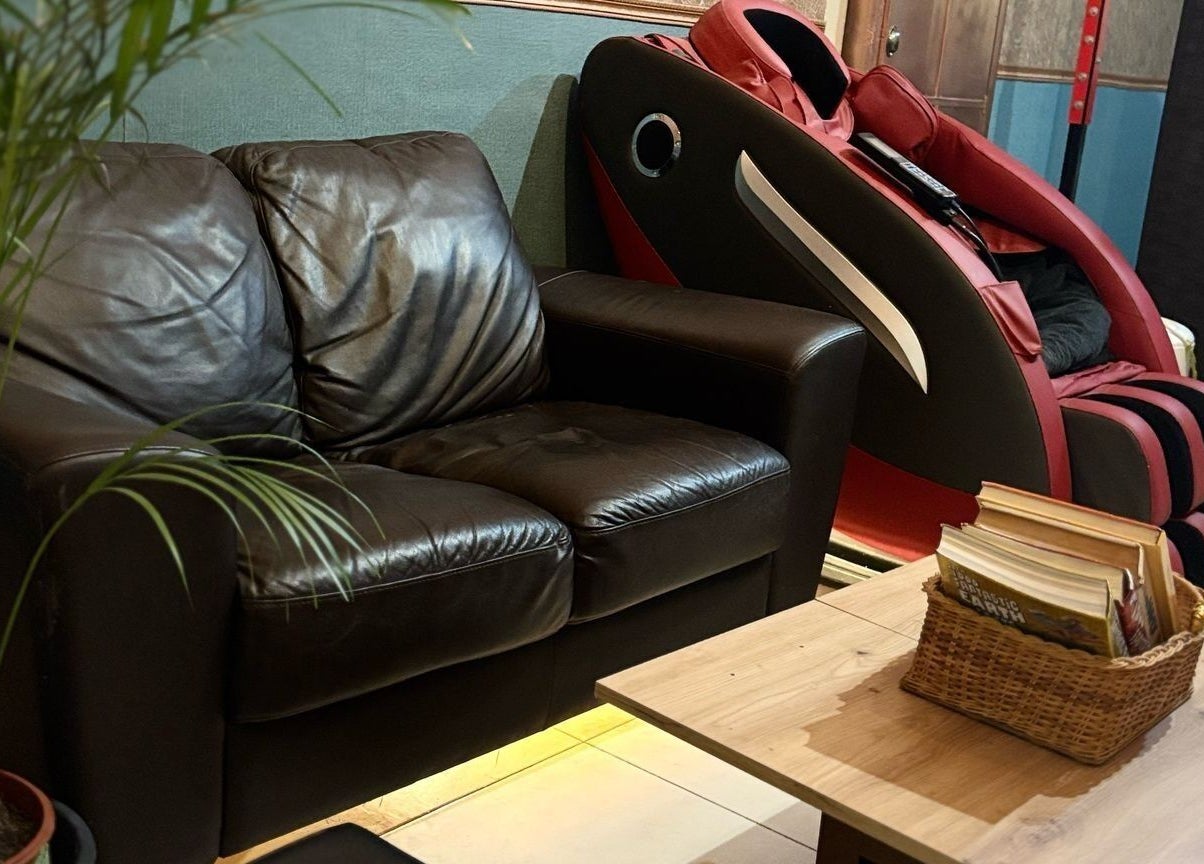 Cozy leather sofa and massage chair at Feniks, Valletta, MT create a relaxing atmosphere for wellness seekers.
