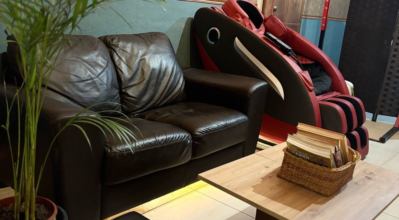 Cozy leather sofa and massage chair at Feniks, Valletta, MT create a relaxing atmosphere for wellness seekers.