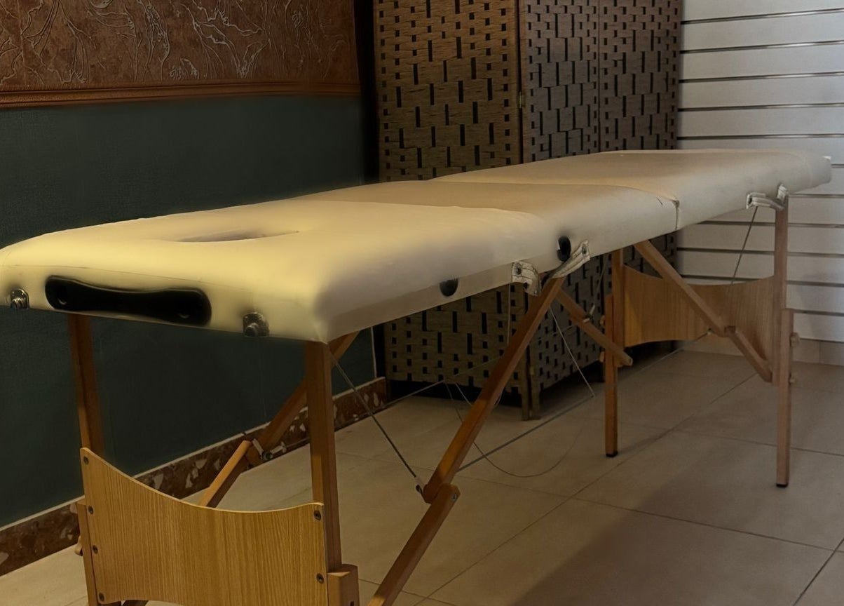 Massage table at Feniks, Valletta, MT, providing comfort and relaxation in a soothing environment.