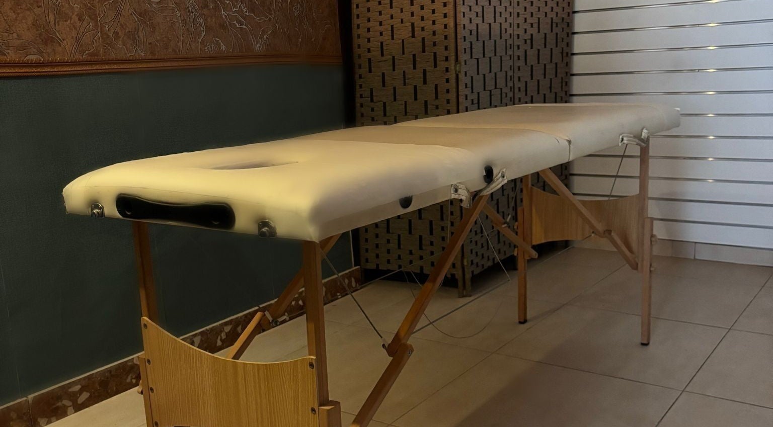 Massage table at Feniks, Valletta, MT, providing comfort and relaxation in a soothing environment.