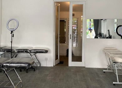 Tattoo and piercing room at Kama Piercing & Tattoo Bali, featuring clean aesthetics. Located in Bali, Bali, ID.