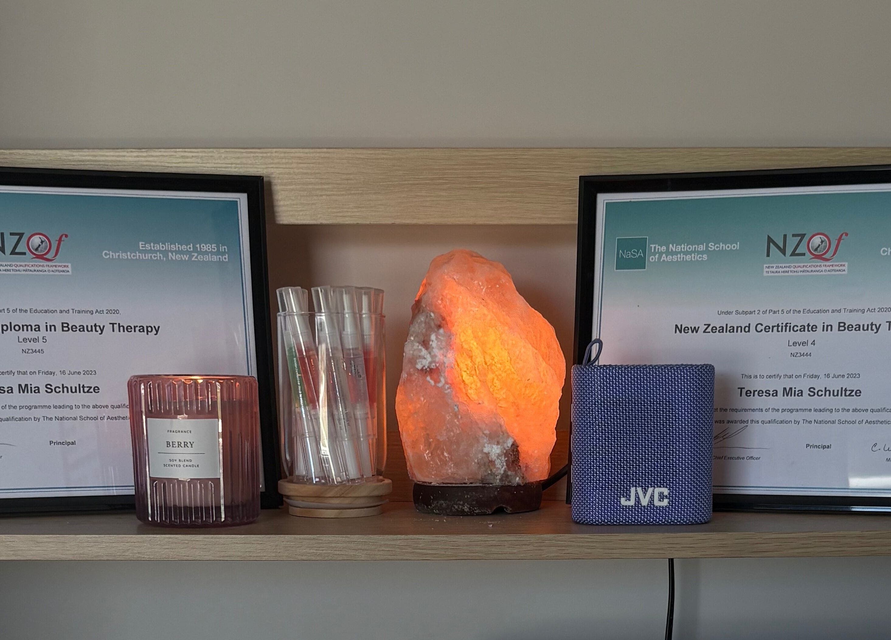 Certificates at Glow Therapy - Beauty by Teresa in Woodend, Canterbury Region, NZ with a glowing salt lamp.