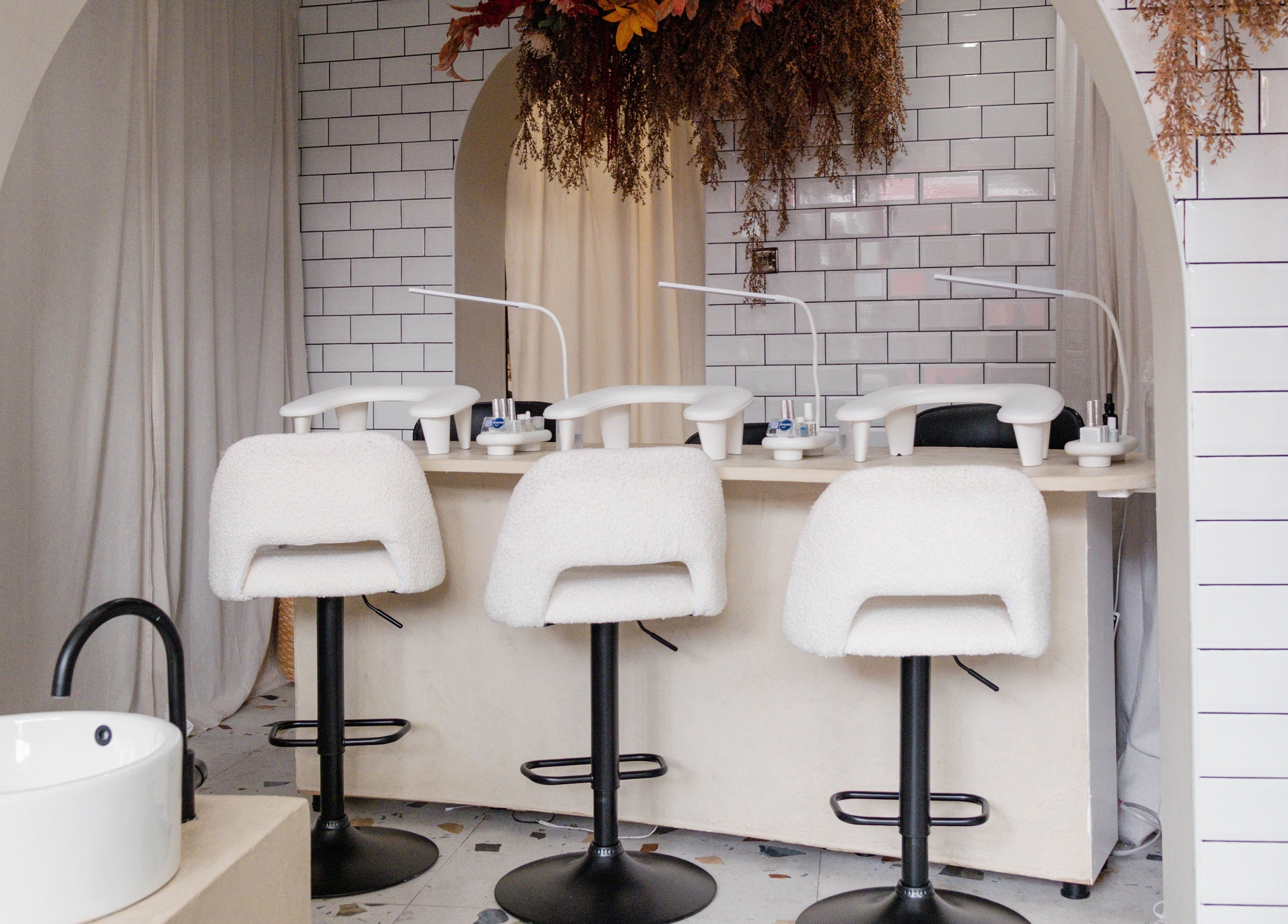 Chic manicure station at Awe London Shoreditch, London, England, GB with modern decor and plush seating.