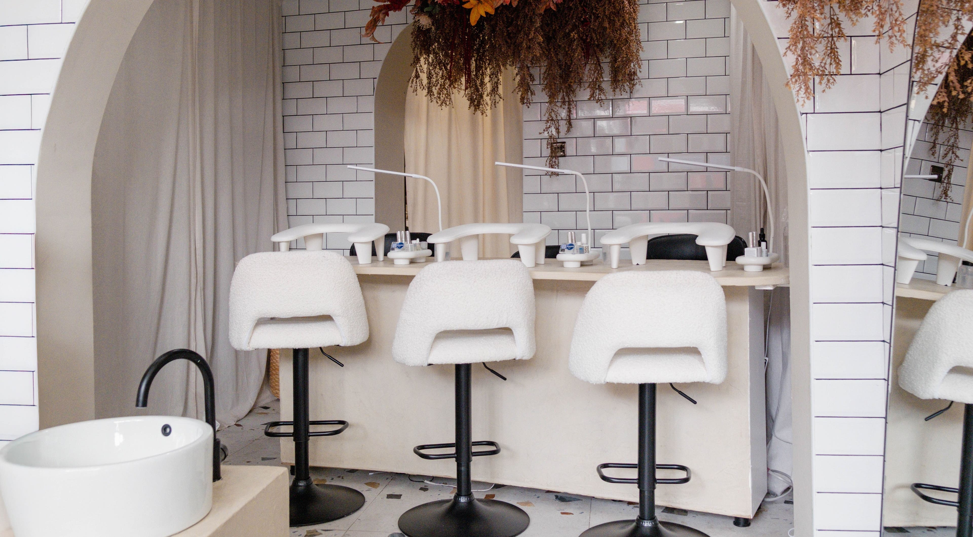 Chic manicure station at Awe London Shoreditch, London, England, GB with modern decor and plush seating.