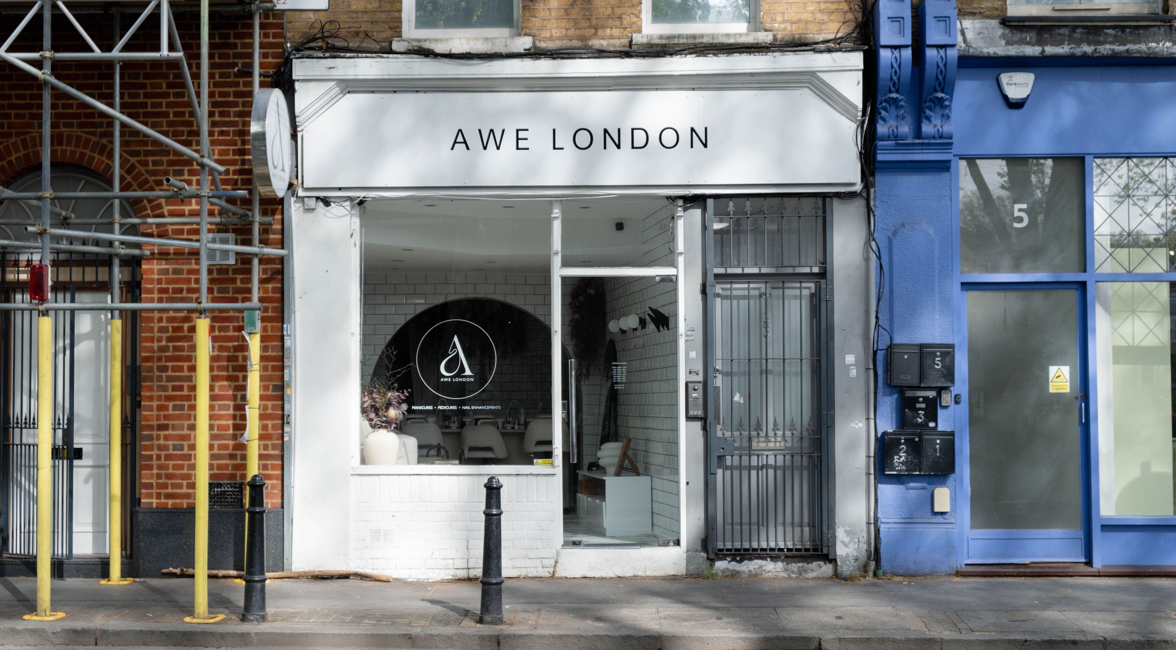 Chic entrance of Awe London Shoreditch beauty salon on a lively street in London, England, GB.