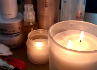 Candles and beauty products at Aura Spa Studio (home), London, England, GB, creating a relaxing atmosphere.