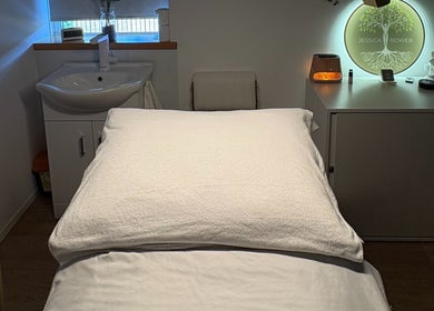 Relaxing treatment room at Jessica Bower Wellness, St Albans, England, GB, with a massage table and serene decor.