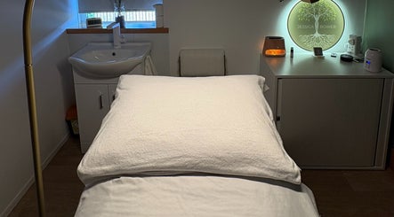 Relaxing treatment room at Jessica Bower Wellness, St Albans, England, GB, with a massage table and serene decor.