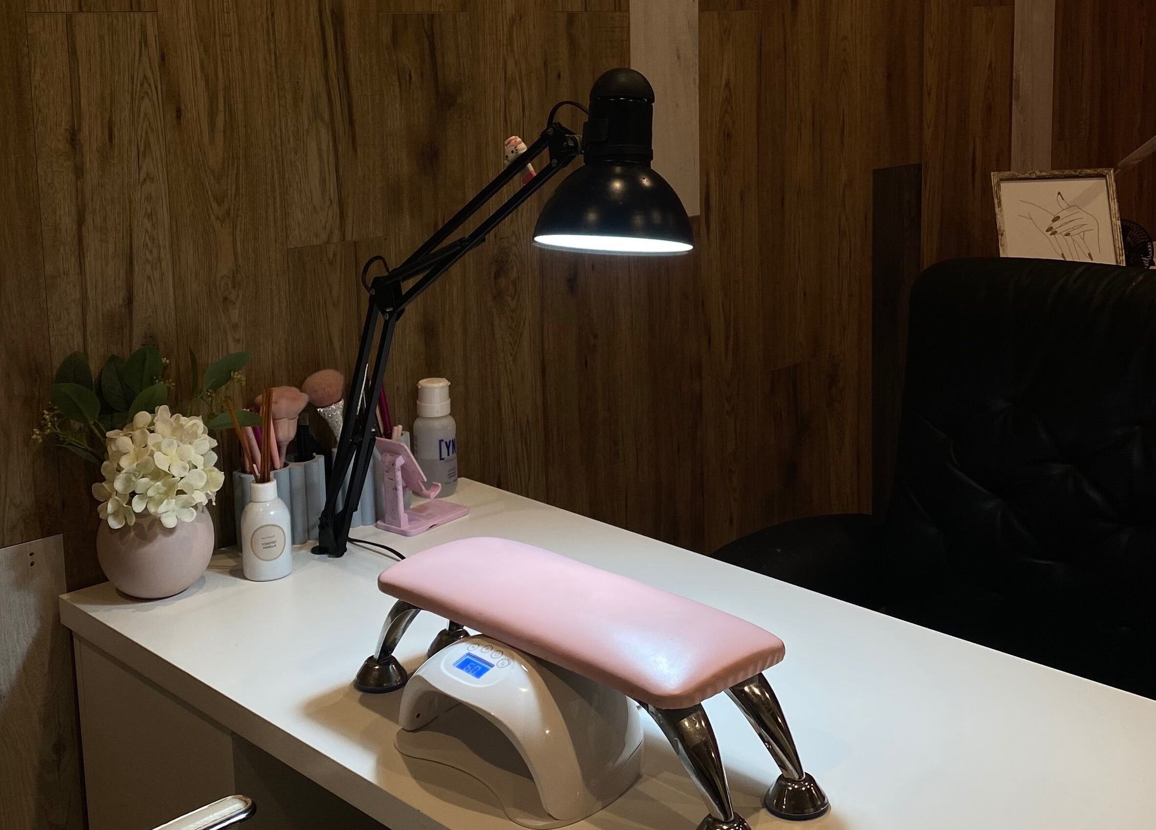 Elegant nail station at Nails by Mia Sara, Melbourne, Victoria, AU, featuring a lamp and manicure essentials.
