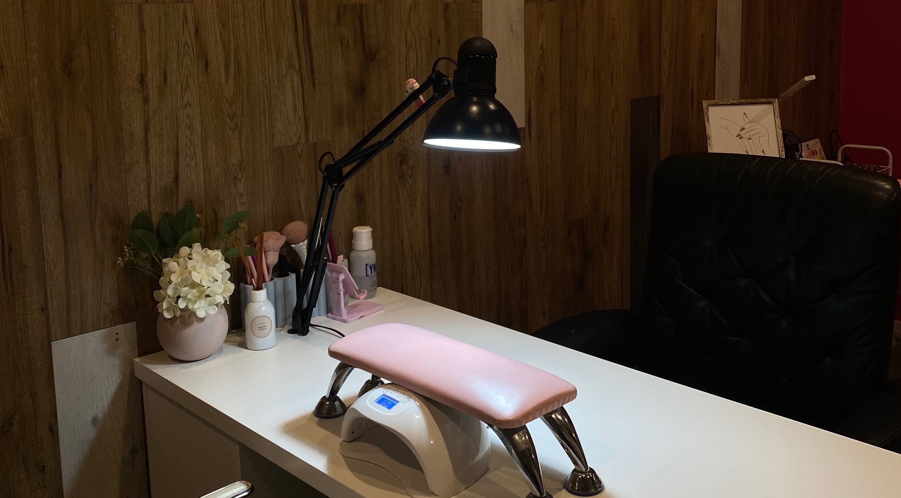 Elegant nail station at Nails by Mia Sara, Melbourne, Victoria, AU, featuring a lamp and manicure essentials.