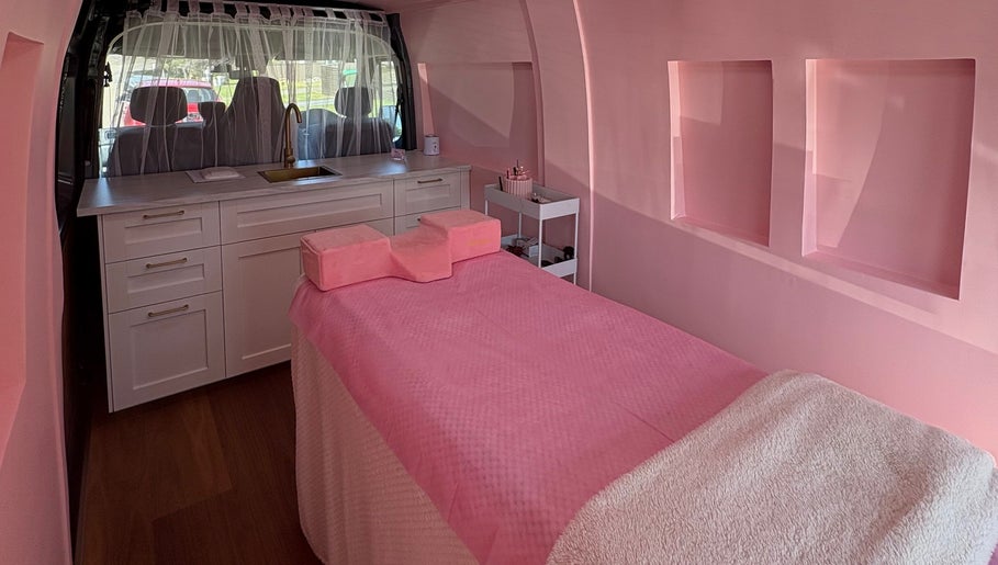 Luxurious interior of The Mobile Lash and Brow Studio, Engadine, New South Wales, AU, with a pink treatment bed.
