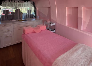 Luxurious interior of The Mobile Lash and Brow Studio, Engadine, New South Wales, AU, with a pink treatment bed.