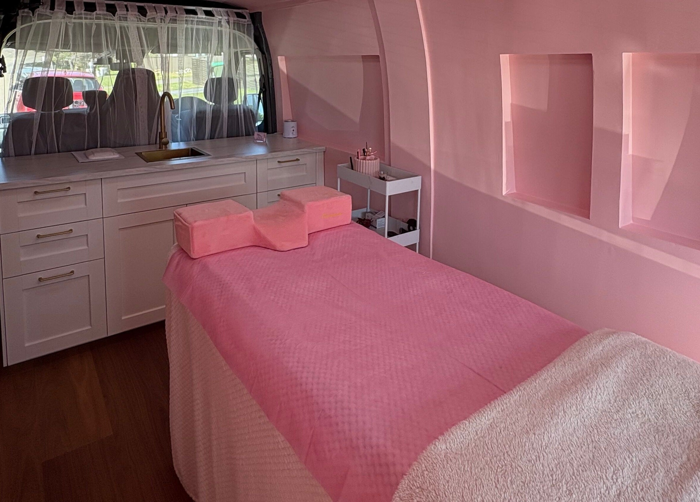 Luxurious interior of The Mobile Lash and Brow Studio, Engadine, New South Wales, AU, with a pink treatment bed.