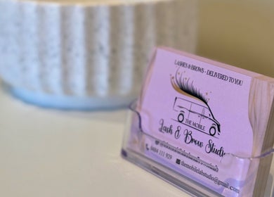 Business cards for The Mobile Lash and Brow Studio in Engadine, New South Wales, AU, neatly displayed.