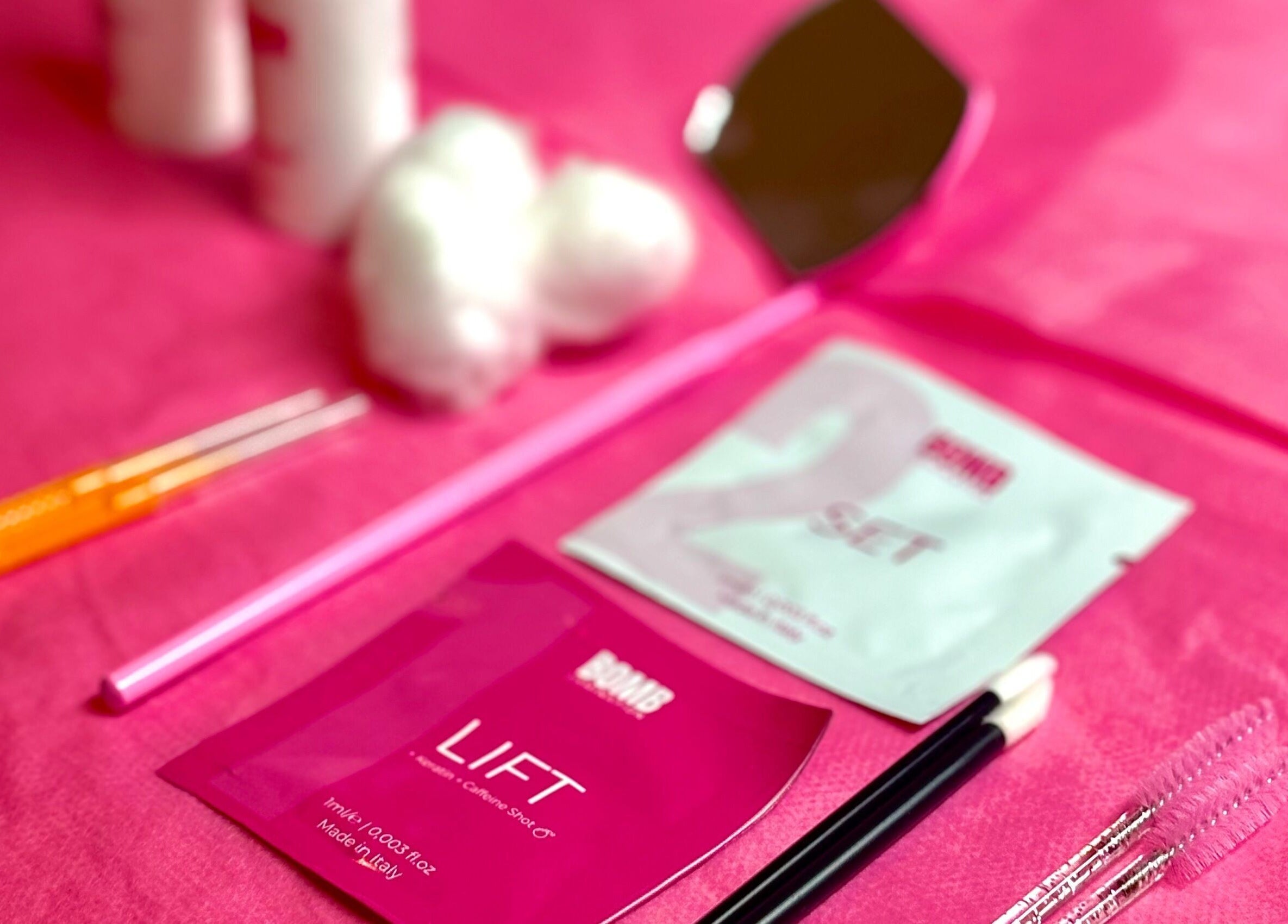 Lash tools and supplies at The Mobile Lash and Brow Studio in Engadine, New South Wales, AU on a pink surface.