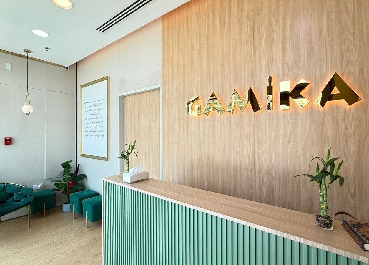 Reception area of Gamika Beauty Salon in دبي, دبي, AE with stylish decor and green seating.