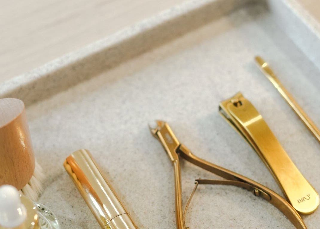 Golden grooming tools at Atelier Evie in Bawtry, England, GB. Enhance beauty naturally.