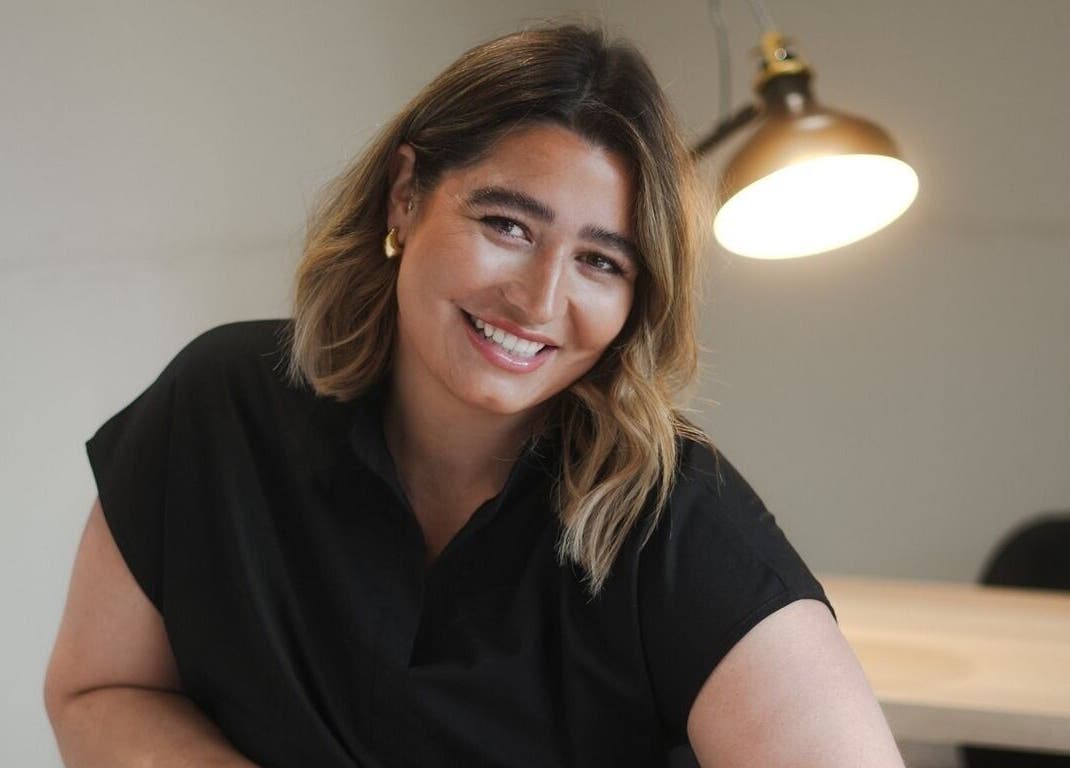 Warm interior at Atelier Evie, Bawtry, England, GB, with a smiling person under soft lamp light.