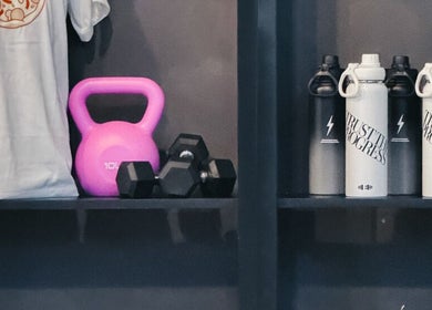 Empower Fitness Studio | Makati showcases kettlebells, dumbbells, and water bottles in Makati City, Metro Manila, PH.