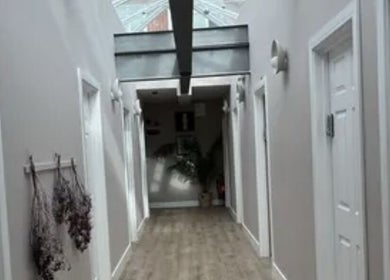 Modern hallway at Precision Sports Therapy, Portsmouth, England, GB, featuring sleek design and natural light.