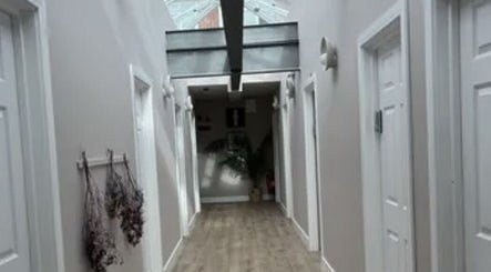 Modern hallway at Precision Sports Therapy, Portsmouth, England, GB, featuring sleek design and natural light.