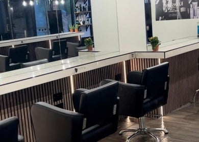 Modern salon seating at James Fulton Hair, Newcastle upon Tyne, England, GB showcasing sleek mirrors and design.