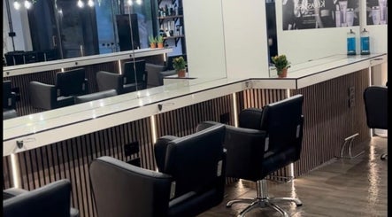 Modern salon seating at James Fulton Hair, Newcastle upon Tyne, England, GB showcasing sleek mirrors and design.
