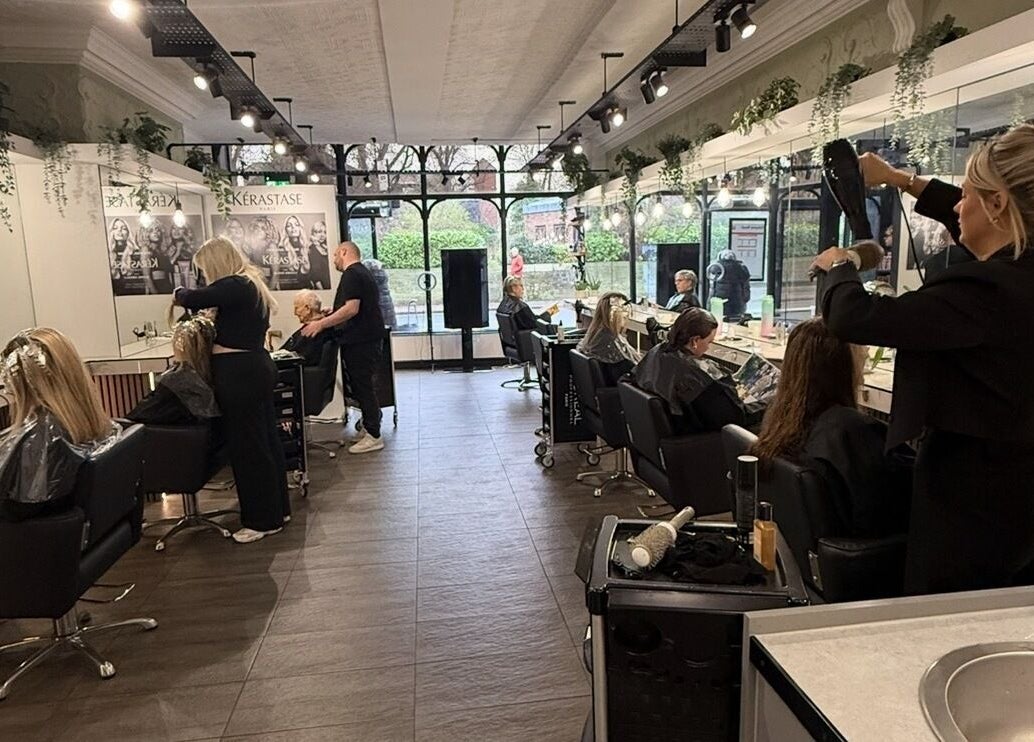 Customers enjoying hair treatments at James Fulton Hair, Newcastle upon Tyne, England, GB. Chic salon interior.