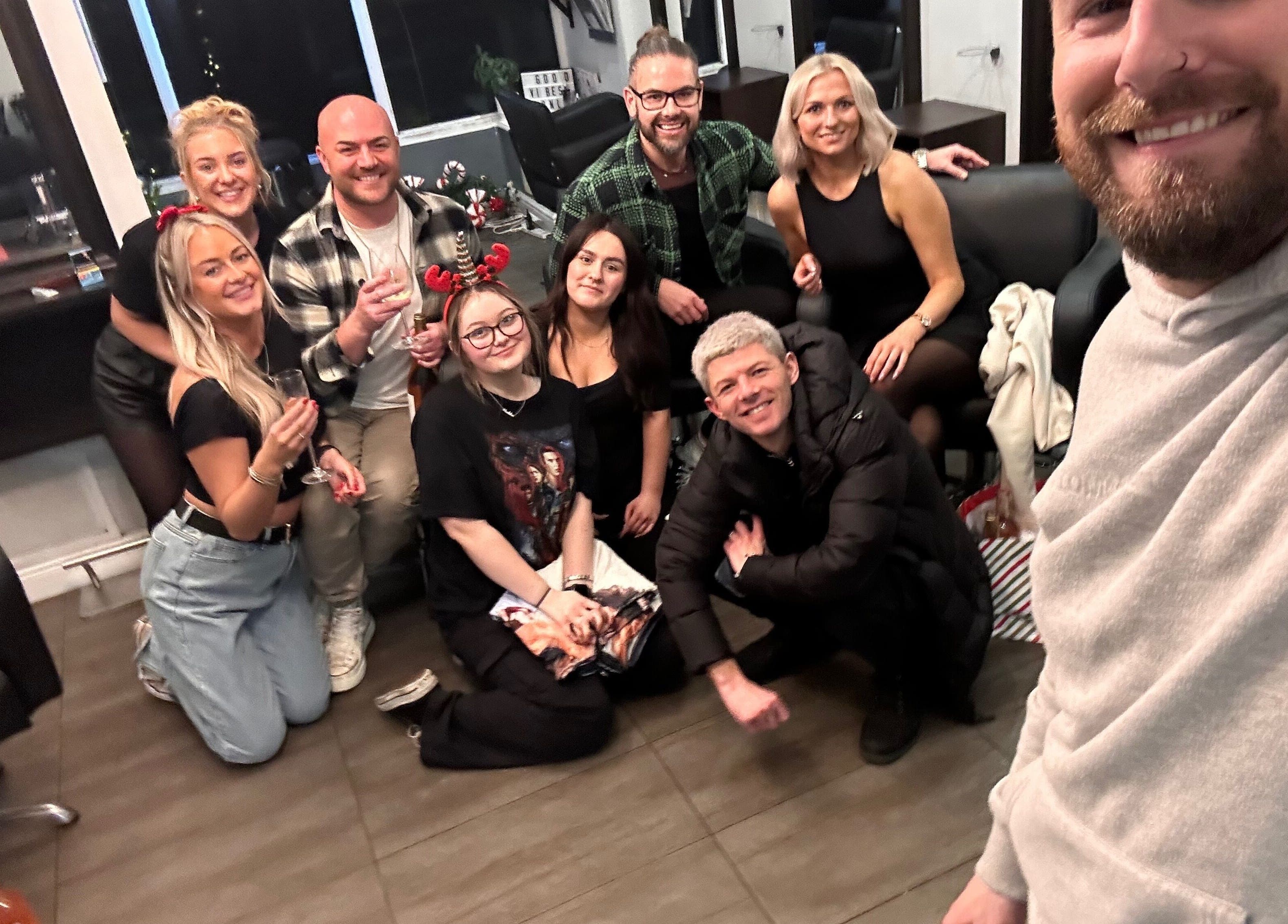 Team celebrating at James Fulton Hair, Newcastle upon Tyne, England, GB with smiles and toasts.