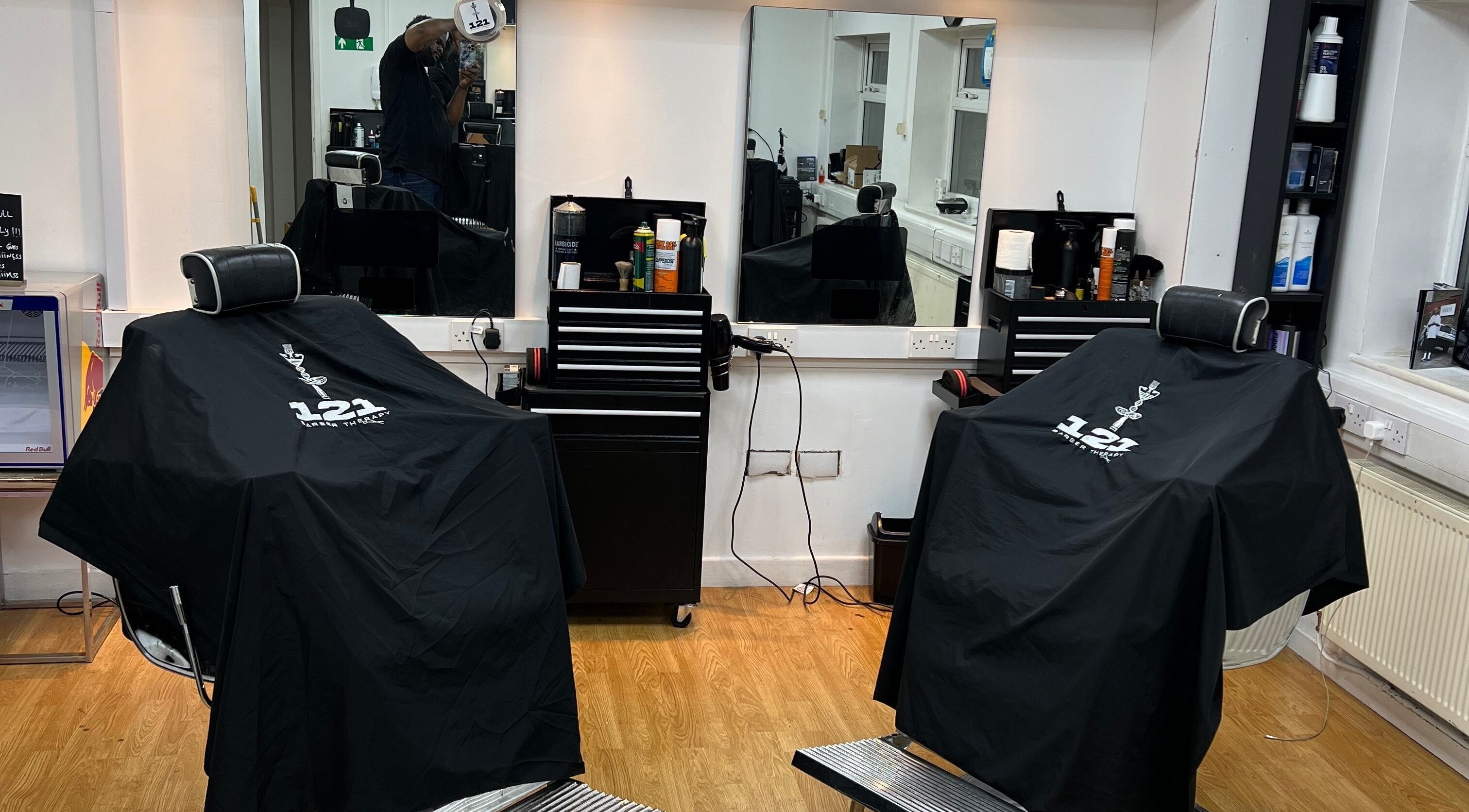 Professional barber chairs at 121 Barber Therapy, Manchester, England, GB, showcasing a sleek, modern setup.