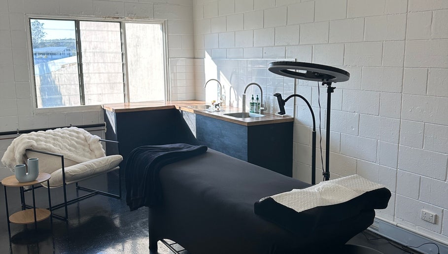 Modern spa room at Morningside - Face Australia Co in Morningside, Queensland, AU with a massage table and cozy seating.