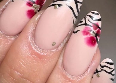 Intricate zebra and floral nail art at Shelby Marie Nail Artistry in Gorleston on Sea, England, GB.