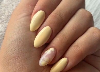 Elegant yellow manicure with artistic feature nail at Shelby Marie Nail Artistry, Gorleston on sea, England, GB.