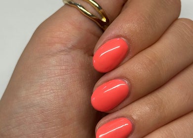 Bright coral nails with glossy finish at Shelby Marie Nail Artistry, Gorleston on Sea, England, GB.