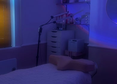A tranquil treatment room at Haus of Belle, Waddesdon, England, GB, featuring a massage table and soft lighting.
