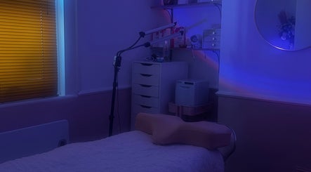 A tranquil treatment room at Haus of Belle, Waddesdon, England, GB, featuring a massage table and soft lighting.